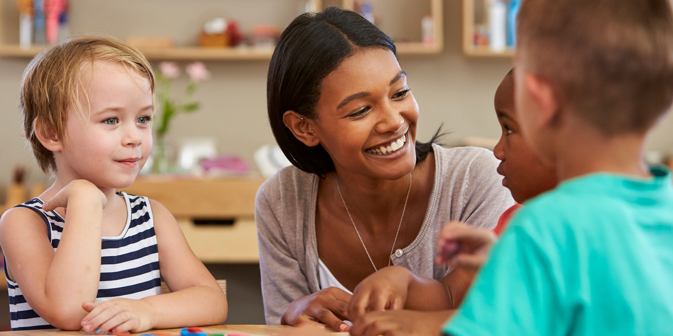 Teacher with kids at the table