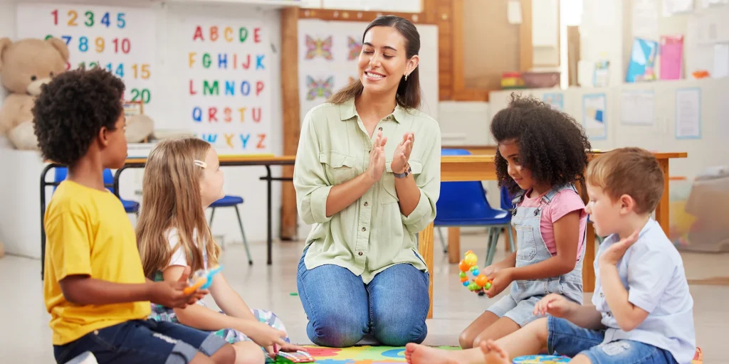 Teacher clapping hands with kids