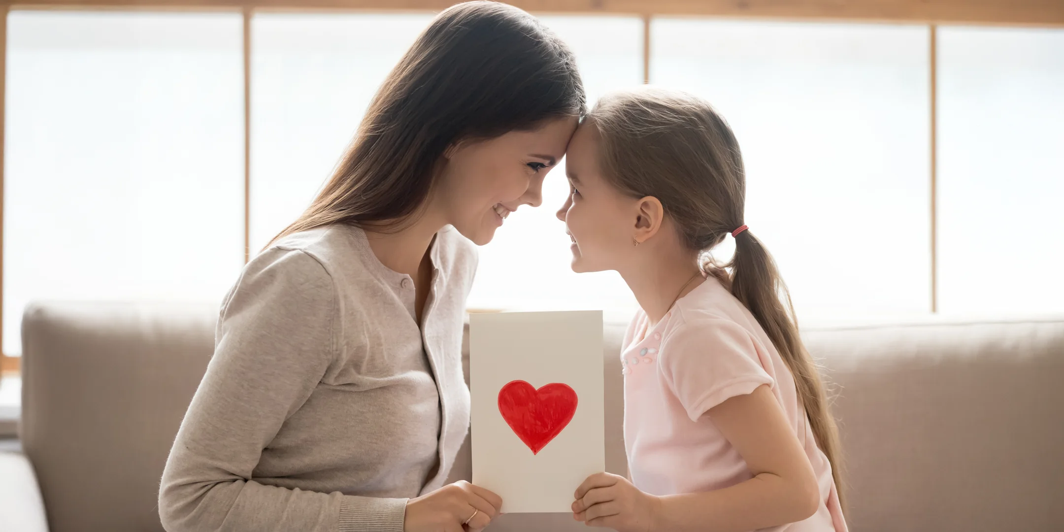 Woman and child holding a valentine